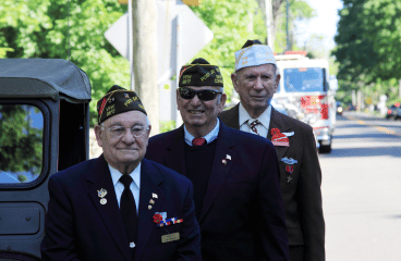 3 Veterans in suits on Veterans day, wearing their VFW member caps